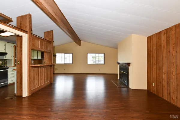 a view of a kitchen with a dishwasher cabinets and a large window