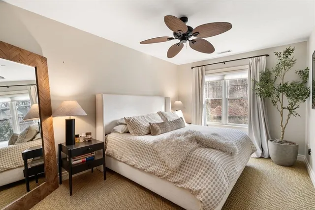 a bedroom with a bed gym equipment and a large window