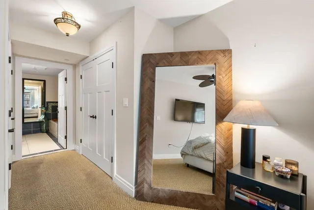 a bedroom with a bed and a mirror