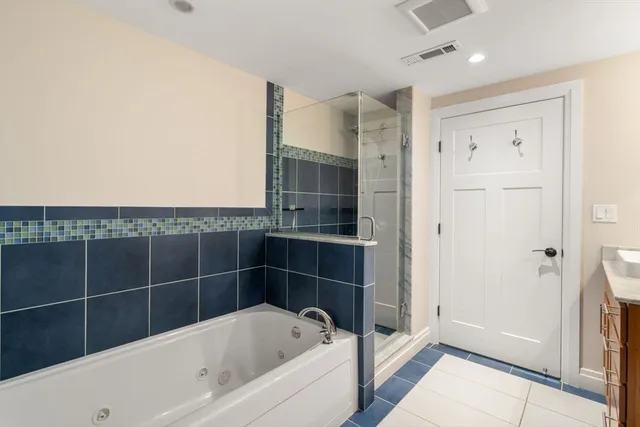 a bathroom with a bathtub and a shower