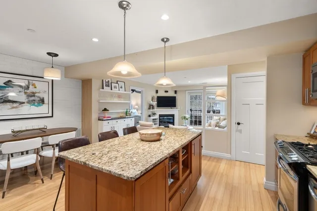 a kitchen with stainless steel appliances granite countertop a sink stove and wooden floor