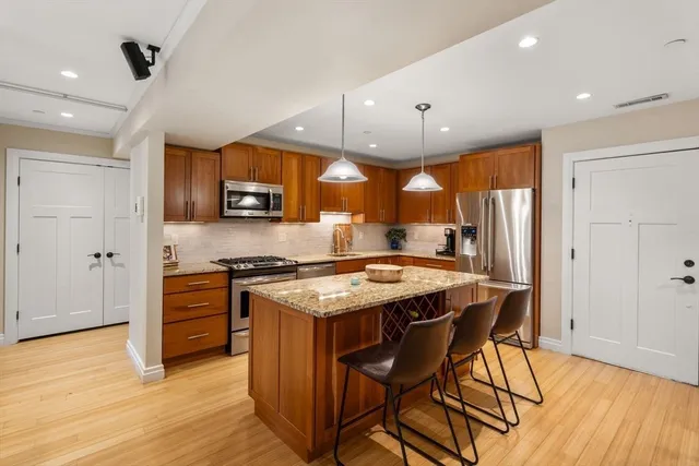 a kitchen with stainless steel appliances granite countertop a stove and a refrigerator