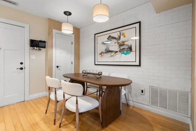 a view of a dining room with furniture wooden floor and a chandelier