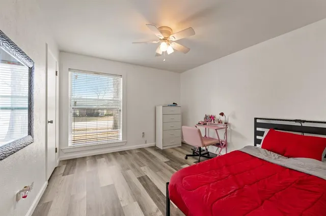 a room with a bed and a ceiling fan