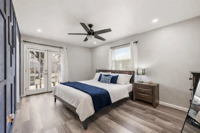 a bedroom with a bed and a ceiling fan