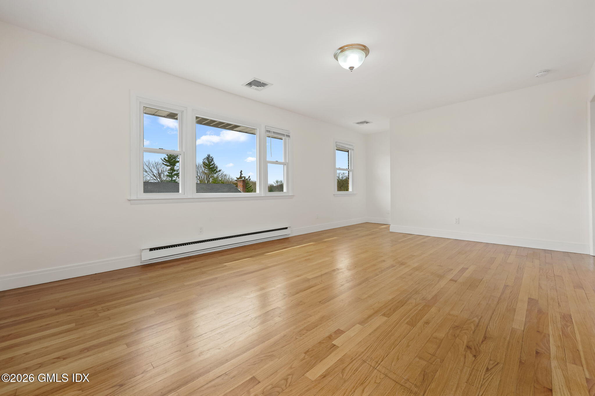 2 Grange Street Greenwich, CT 06830 - Photo 16 of 31 an empty room with wooden floor and windows