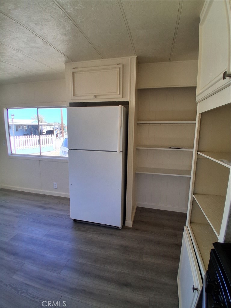 4561 Adobe Road, Unit 40 Twentynine Palms, CA 92277 - Photo 18 of 29 a white refrigerator freezer and a stove sitting inside of a kitchen