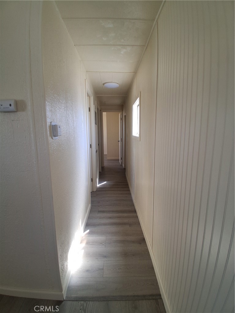 4561 Adobe Road, Unit 40 Twentynine Palms, CA 92277 - Photo 20 of 29 a view of a hallway with wooden floor