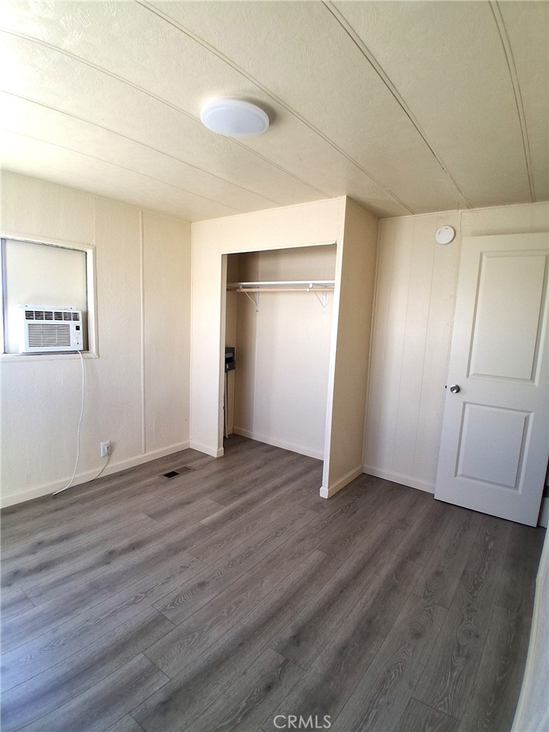 4561 Adobe Road, Unit 40 Twentynine Palms, CA 92277 - Photo 28 of 29 an empty room with wooden floor & closet area