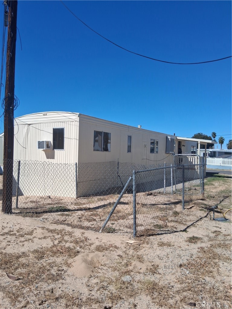 4561 Adobe Road, Unit 40 Twentynine Palms, CA 92277 - Photo 4 of 29 a view of backyard with wooden fence