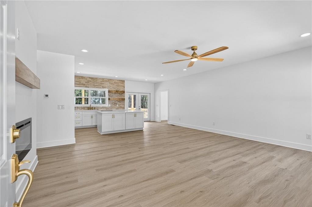 88 Carolyn Path Rockmart, GA 30153 - Photo 7 of 73 an empty room with wooden floor and a ceiling fan