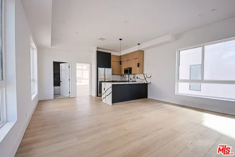 a view of a kitchen with a stove cabinets and wooden floor