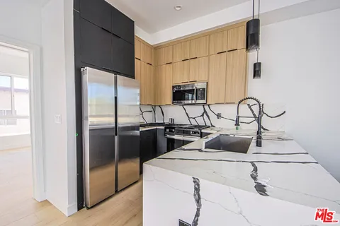 a kitchen with a sink and a refrigerator