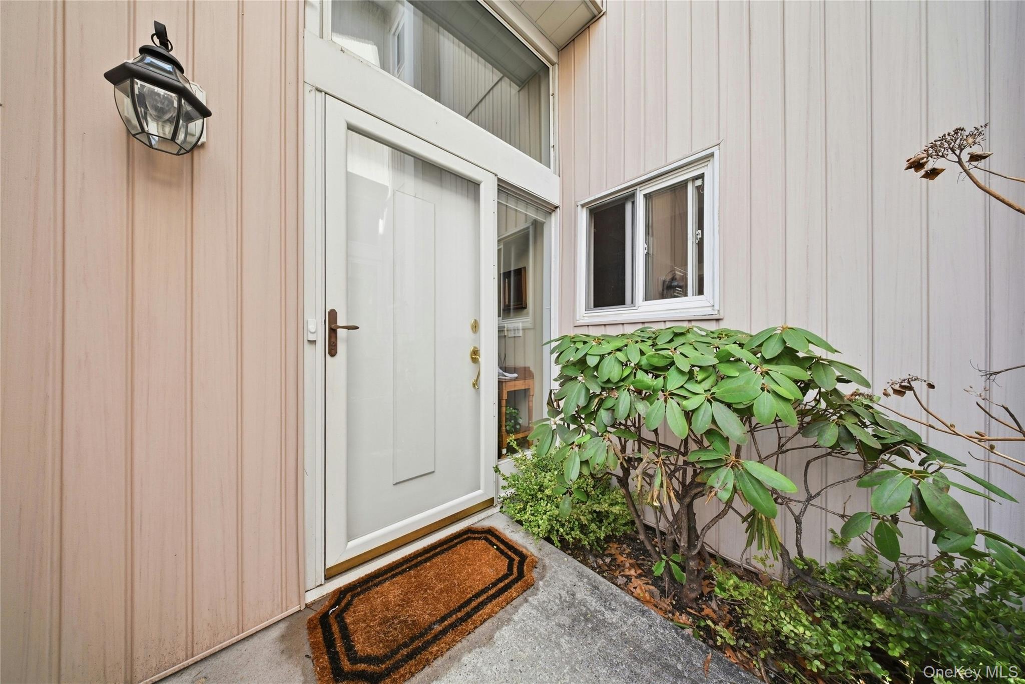 78 Hidden Ridge Drive Syosset, NY 11791 - Photo 2 of 21 a view of an entryway with a flower pot