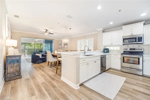 a kitchen with stove a sink and appliances