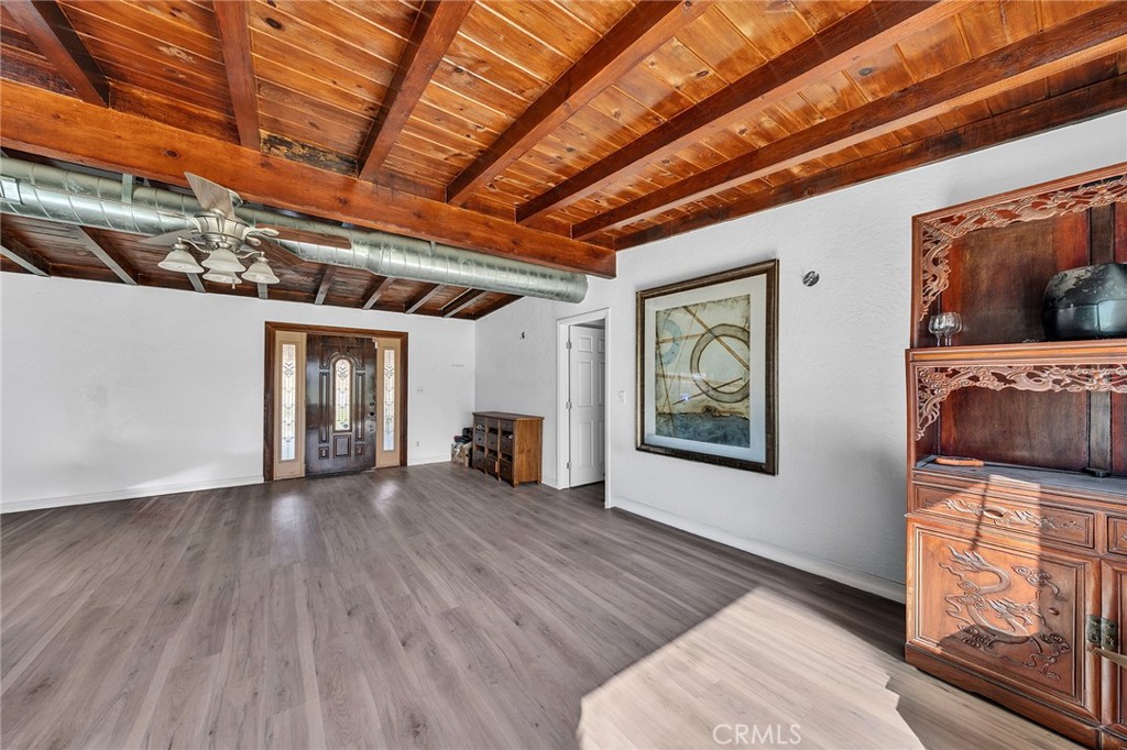 31516 Clay River Road Barstow, CA 92311 - Photo 15 of 73 a view of an empty room with wooden floor and a window