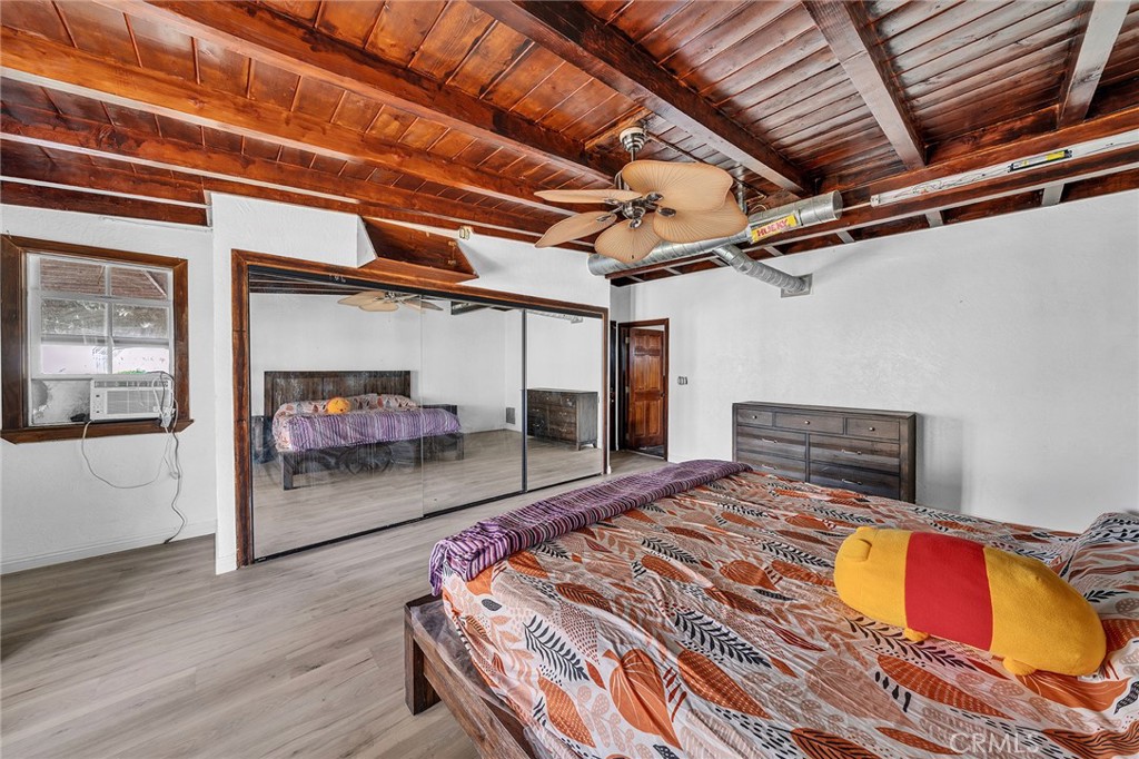 31516 Clay River Road Barstow, CA 92311 - Photo 23 of 73 a bedroom with a bed and wooden floor