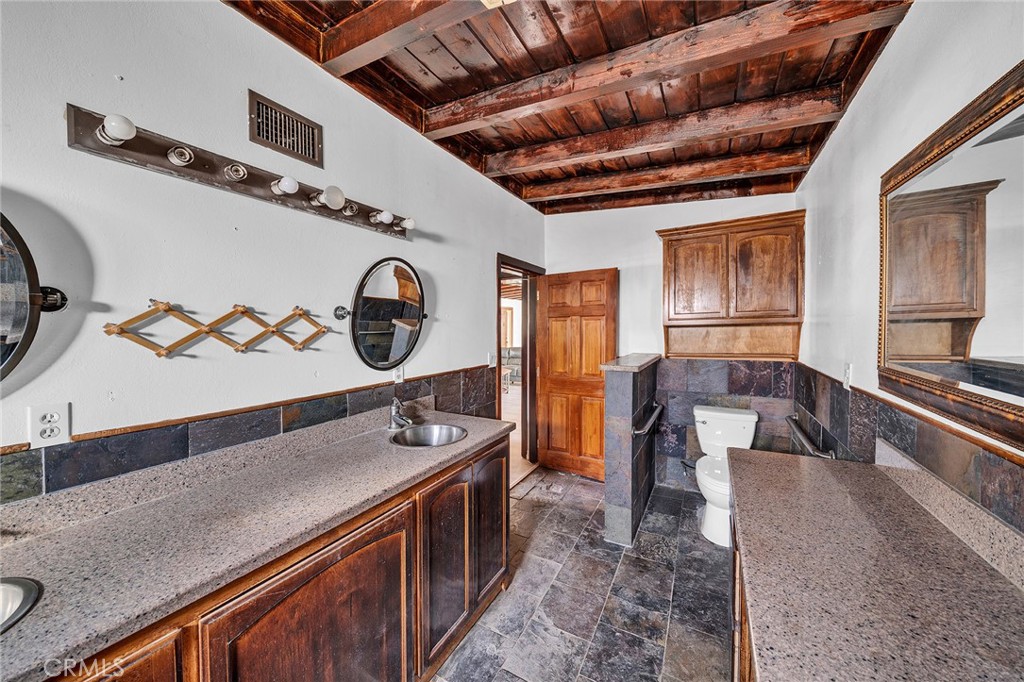 31516 Clay River Road Barstow, CA 92311 - Photo 27 of 73 a kitchen with stainless steel appliances granite countertop a sink a stove and a wooden cabinets