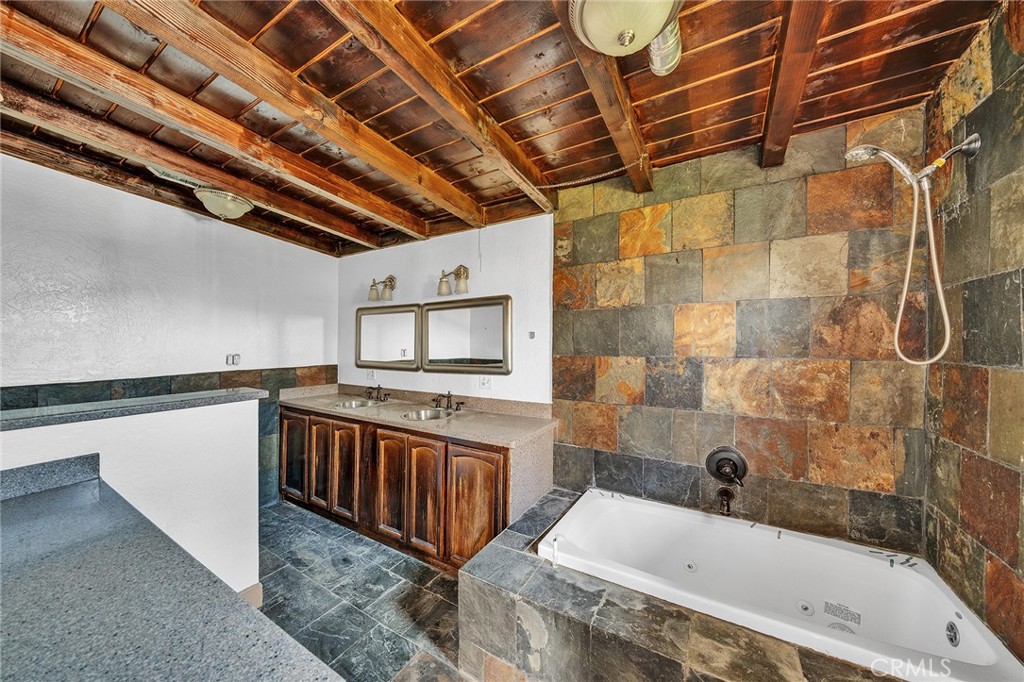 31516 Clay River Road Barstow, CA 92311 - Photo 48 of 73 a bathroom with a tub a sink and a shower