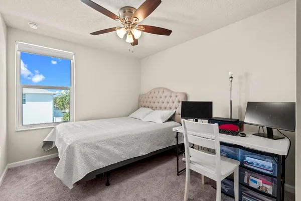 a bedroom with a bed and a desk
