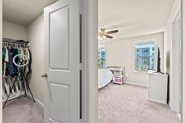 a view of walk in closet with clothes and shoes