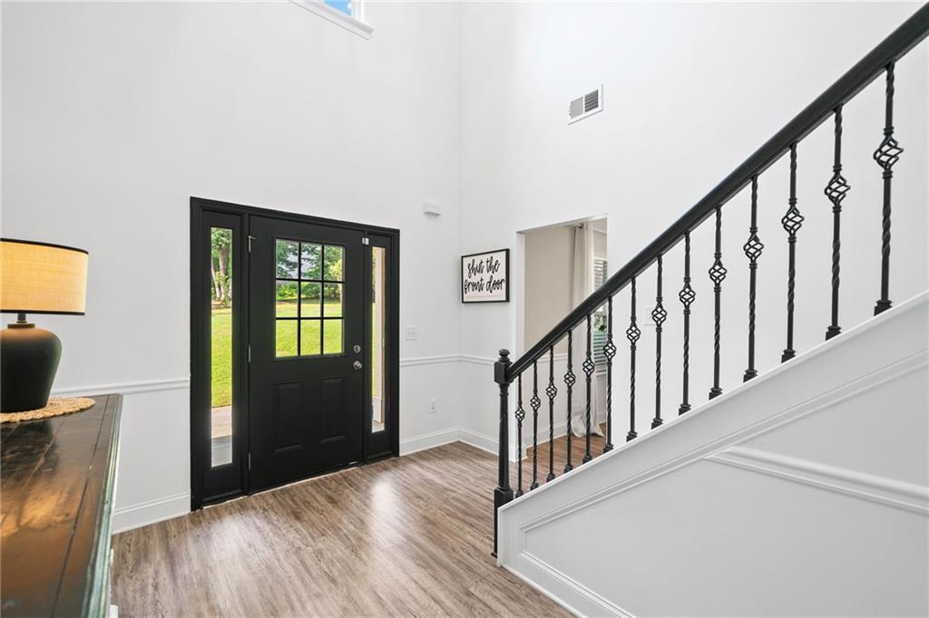13 Four Feathers Lane Northeast Rydal, GA 30171 - Photo 10 of 51 a view of a hallway with wooden floor and stairs