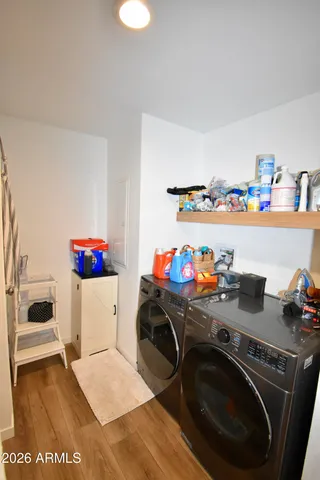 a utility room with sink dryer and washer