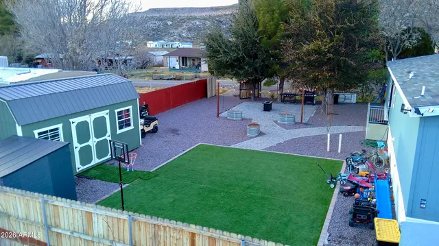 a view of a backyard with plants and a fire pit