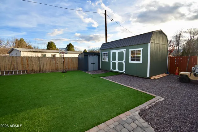 a view of a house with backyard and porch