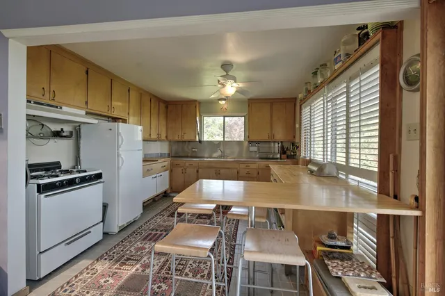 a kitchen with granite countertop a stove cabinets and refrigerator
