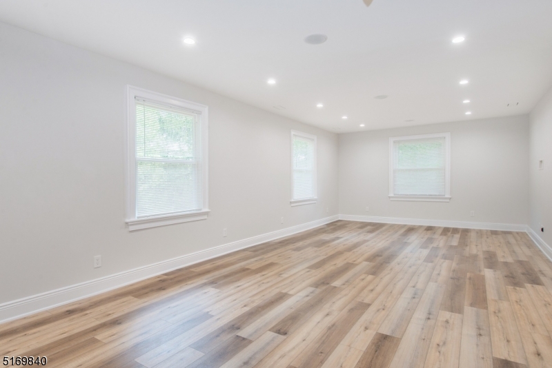 31-37 Oak Grove Road, Unit 2 Caldwell, NJ 07006 - Photo 11 of 34 an empty room with wooden floor and windows