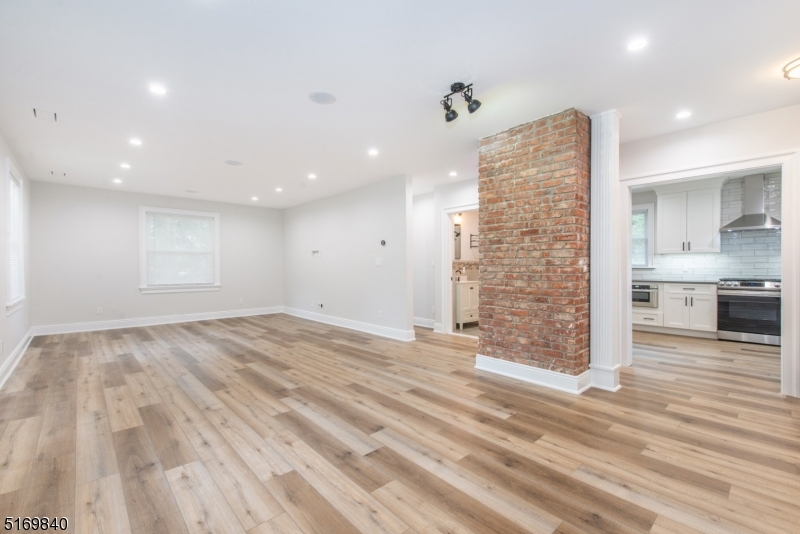 31-37 Oak Grove Road, Unit 2 Caldwell, NJ 07006 - Photo 12 of 34 an empty room with wooden floor and windows
