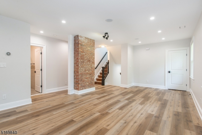 31-37 Oak Grove Road, Unit 2 Caldwell, NJ 07006 - Photo 15 of 34 a view of an empty room with wooden floor and stairs