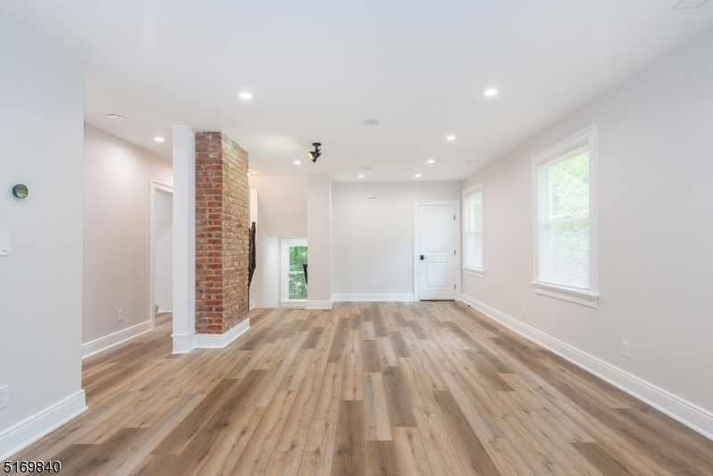 31-37 Oak Grove Road, Unit 2 Caldwell, NJ 07006 - Photo 16 of 34 a view of an empty room with a window and wooden floor