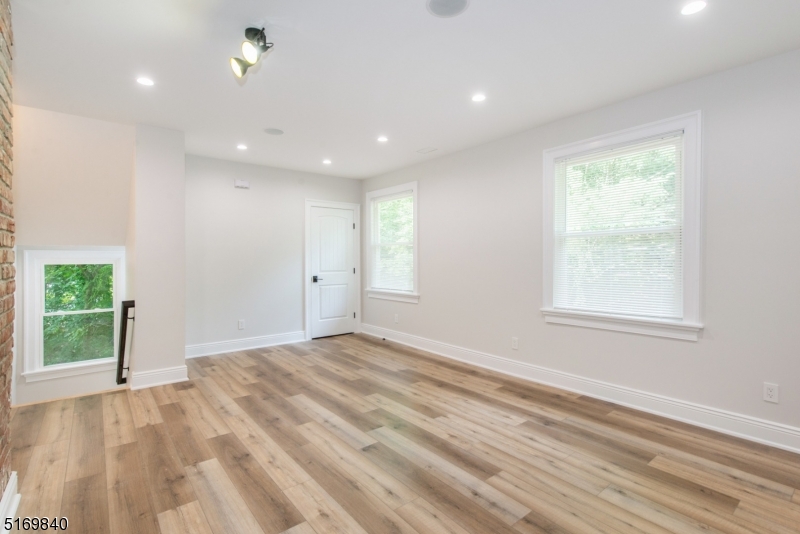 31-37 Oak Grove Road, Unit 2 Caldwell, NJ 07006 - Photo 17 of 34 a view of an empty room with wooden floor and a window