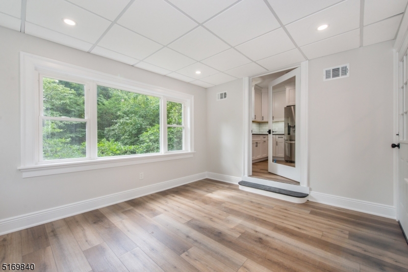 31-37 Oak Grove Road, Unit 2 Caldwell, NJ 07006 - Photo 20 of 34 an empty room with wooden floor and windows