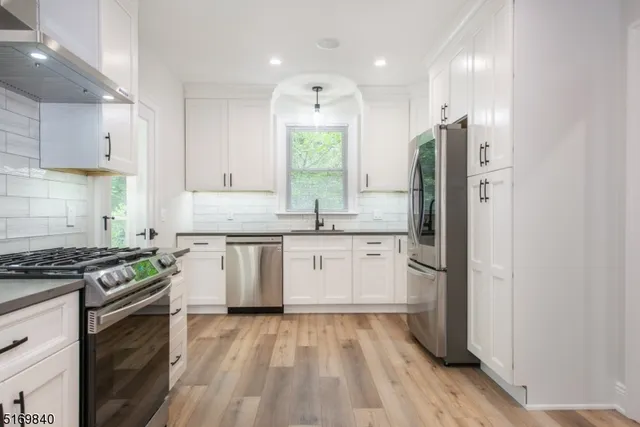 a kitchen with a sink stove and refrigerator