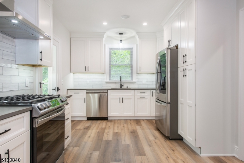 31-37 Oak Grove Road, Unit 2 Caldwell, NJ 07006 - Photo 2 of 34 a kitchen with a sink stove and refrigerator