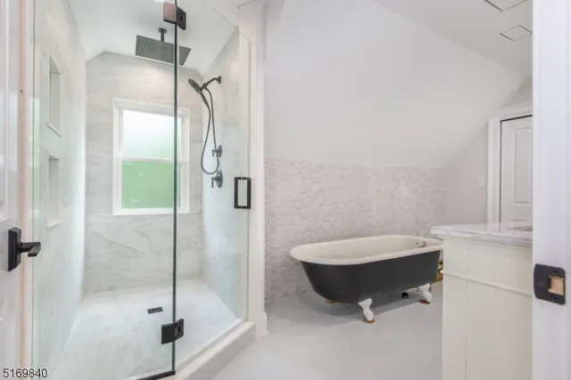 a bathroom with a tub and shower