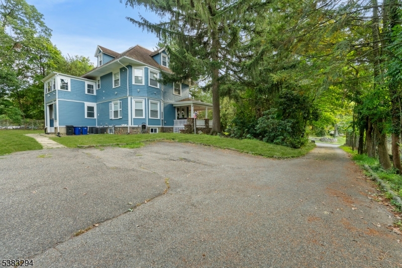 31-37 Oak Grove Road, Unit 2 Caldwell, NJ 07006 - Photo 31 of 34 a view of a big house with a big yard and large trees