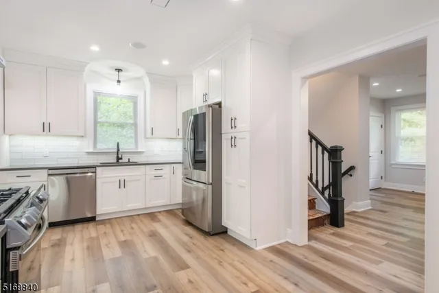 a kitchen with a refrigerator and a sink