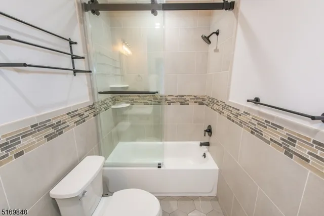 a bathroom with a shower a toilet and sink