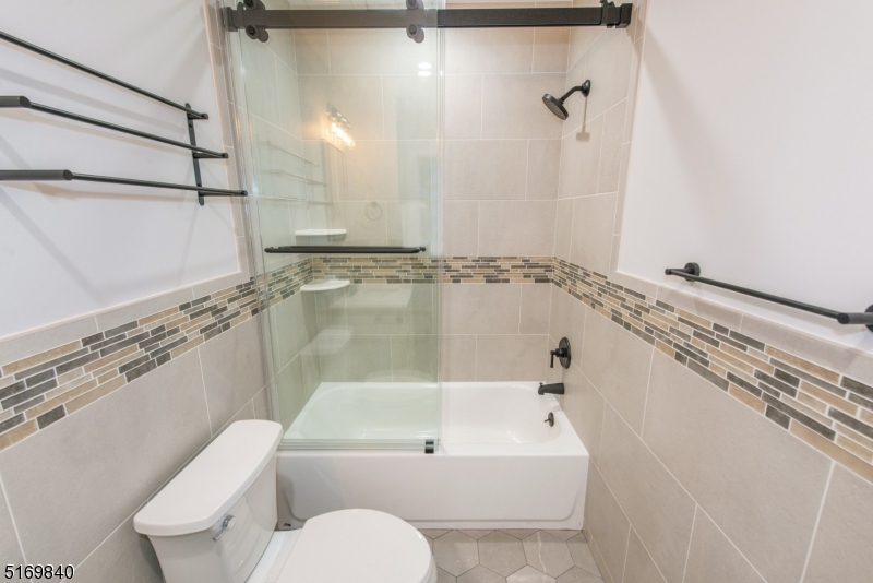 31-37 Oak Grove Road, Unit 2 Caldwell, NJ 07006 - Photo 9 of 34 a bathroom with a shower a toilet and sink