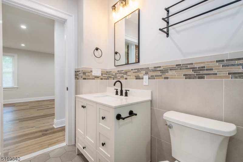31-37 Oak Grove Road, Unit 2 Caldwell, NJ 07006 - Photo 10 of 34 a bathroom with a sink a toilet and shower