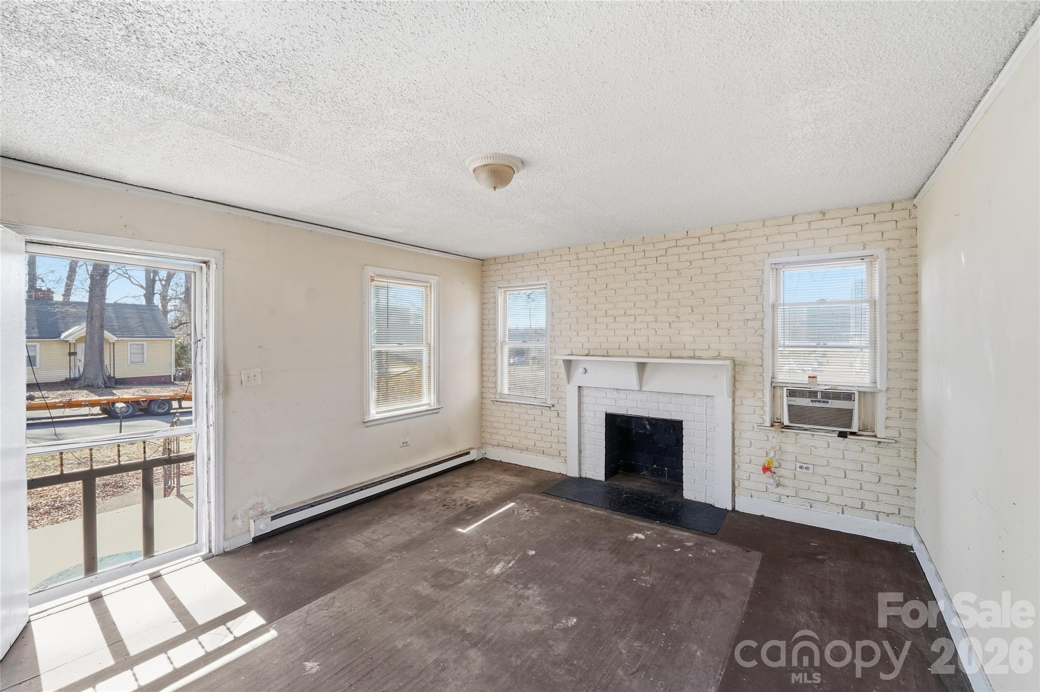 3309 Ritch Avenue Charlotte, NC 28206 - Photo 2 of 25 a view of a livingroom with an empty space and a fireplace