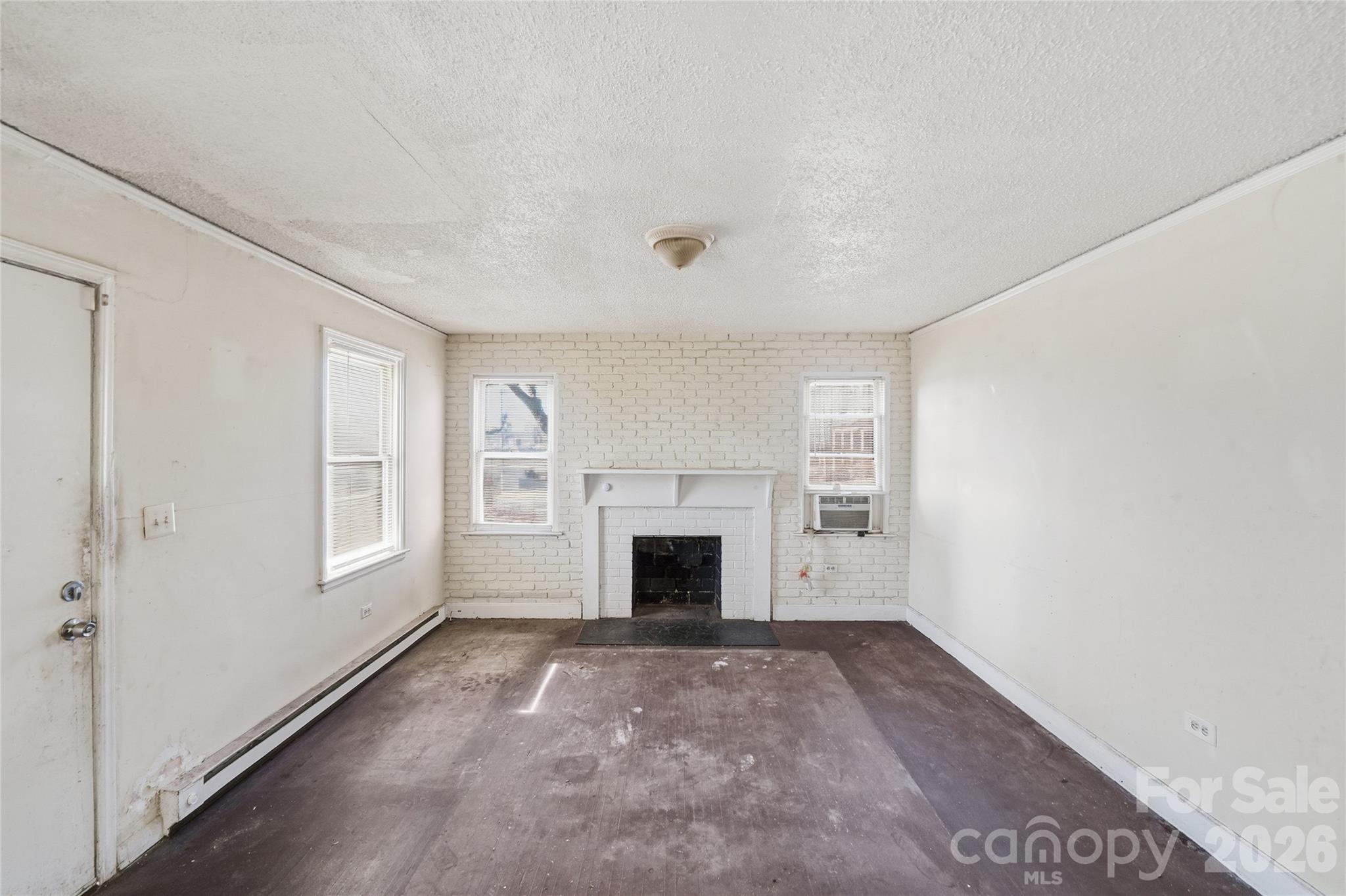 3309 Ritch Avenue Charlotte, NC 28206 - Photo 8 of 25 an empty room with windows and fireplace