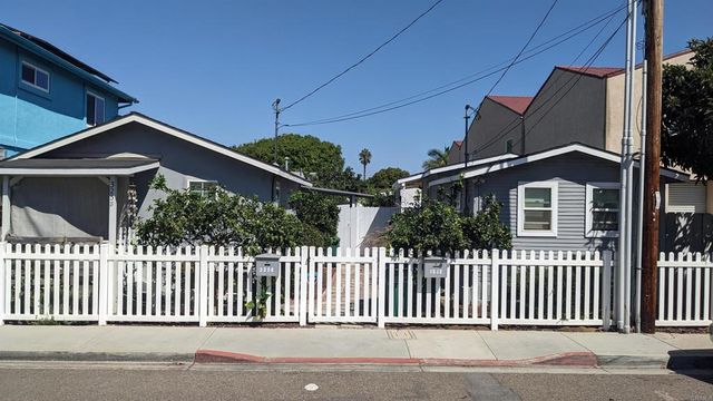 a front view of a house with a fence