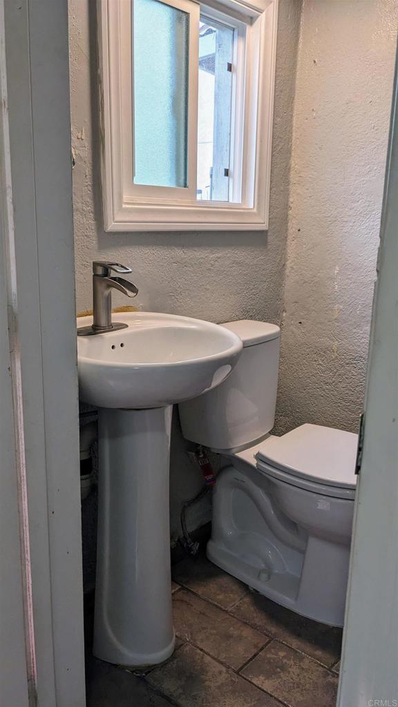 3258 Tyler Street Carlsbad, CA 92008 - Photo 11 of 27 a bathroom with a sink a toilet and a mirror