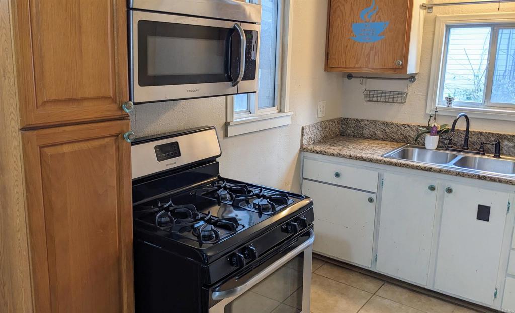 3258 Tyler Street Carlsbad, CA 92008 - Photo 2 of 27 a kitchen with granite countertop a stove and a microwave