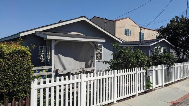 a view of a house with wooden fence